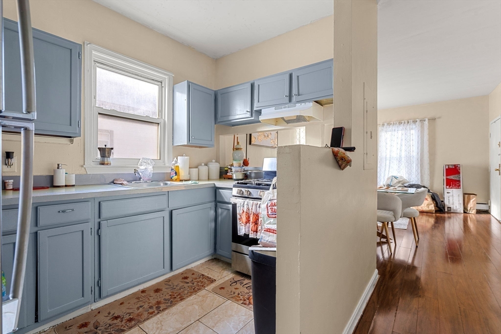 90 Timson Street Lynn, MA 01902 - Photo 22 of 38 a kitchen with a refrigerator and wooden floor