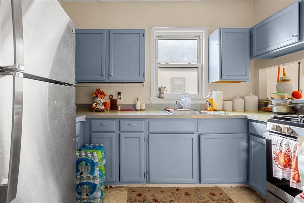 90 Timson Street Lynn, MA 01902 - Photo 23 of 38 a kitchen with a sink cabinets and appliances