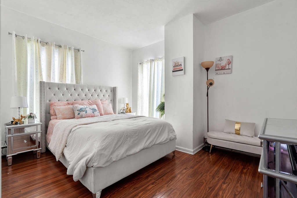 90 Timson Street Lynn, MA 01902 - Photo 25 of 38 a bedroom with a bed and a book shelf