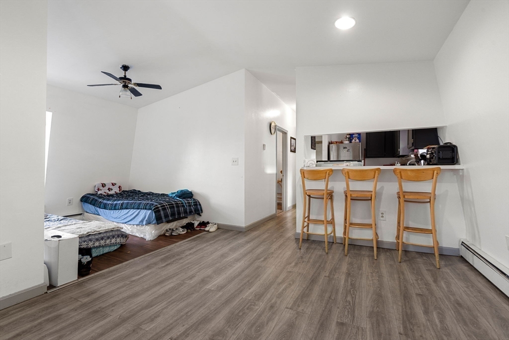 90 Timson Street Lynn, MA 01902 - Photo 30 of 38 a living room with a couch and a table with wooden floor