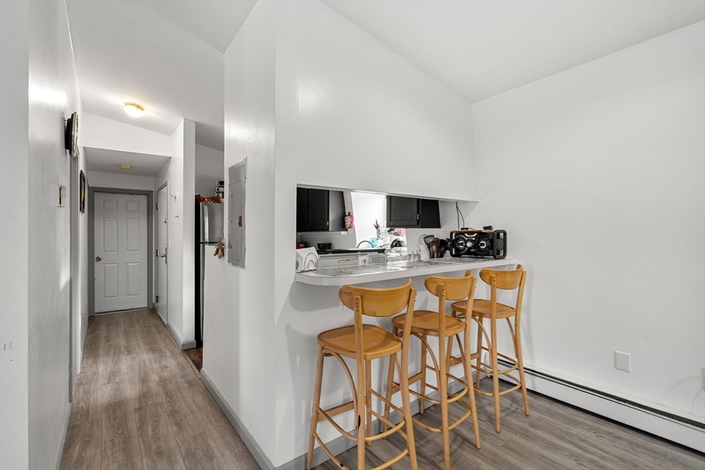 90 Timson Street Lynn, MA 01902 - Photo 31 of 38 a kitchen with stainless steel appliances kitchen island granite countertop a refrigerator and microwave