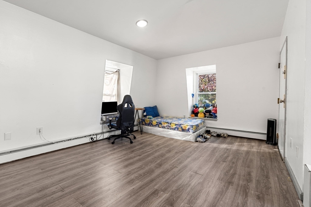90 Timson Street Lynn, MA 01902 - Photo 32 of 38 a view of a workspace with furniture and wooden floor