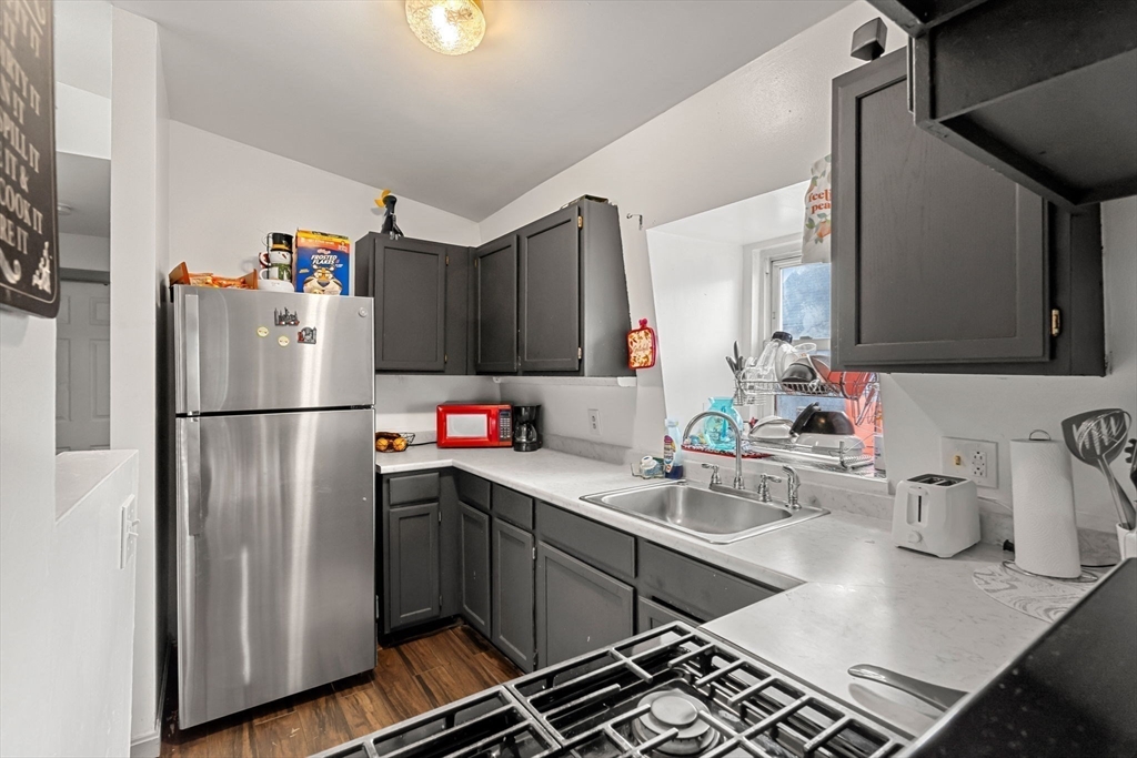 90 Timson Street Lynn, MA 01902 - Photo 35 of 38 a kitchen with a refrigerator and a sink