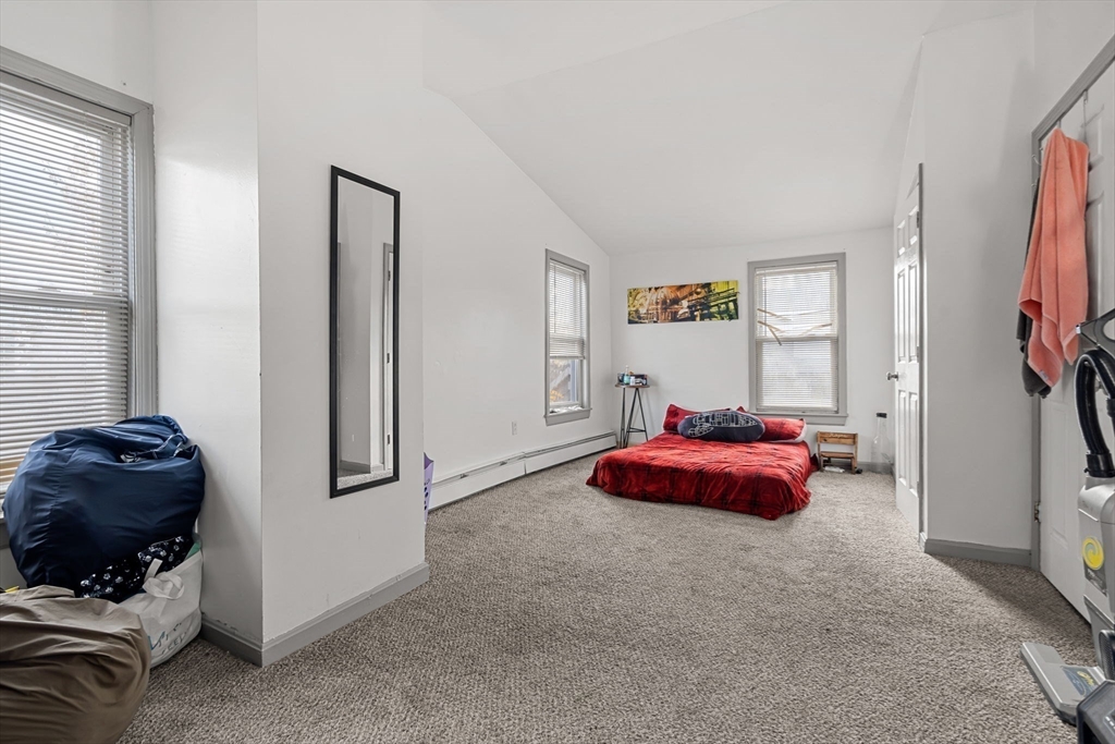 90 Timson Street Lynn, MA 01902 - Photo 37 of 38 a bedroom with a bed and a chandelier
