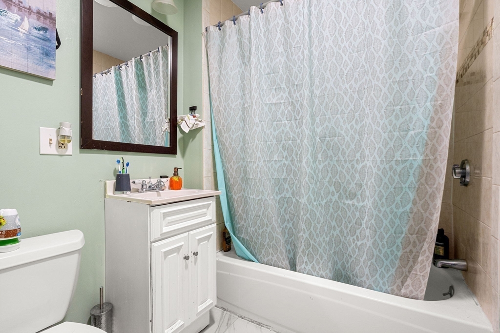 90 Timson Street Lynn, MA 01902 - Photo 38 of 38 a bathroom with a sink a toilet and a mirror