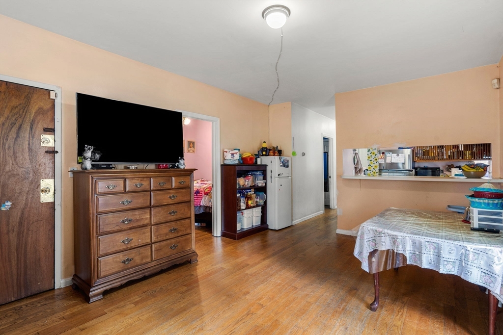 90 Timson Street Lynn, MA 01902 - Photo 10 of 38 a living room with furniture and a flat screen tv