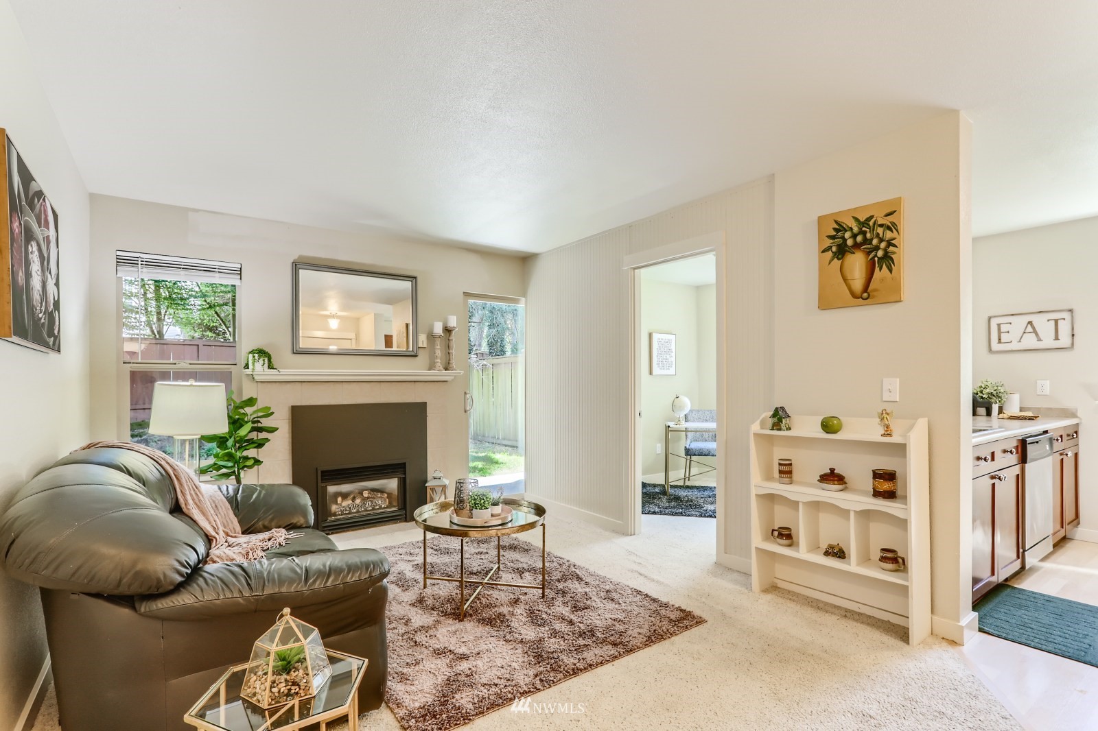 9805 Avondale Road Northeast, Unit X162 Redmond, WA 98052 - Photo 1 of 19 a living room with furniture a fireplace with wooden floor