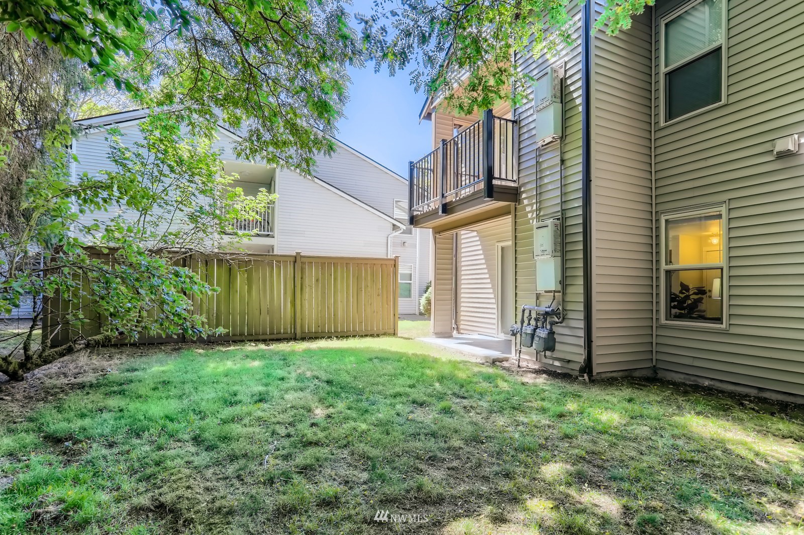9805 Avondale Road Northeast, Unit X162 Redmond, WA 98052 - Photo 13 of 19 a view of a backyard with potted plants and a large tree