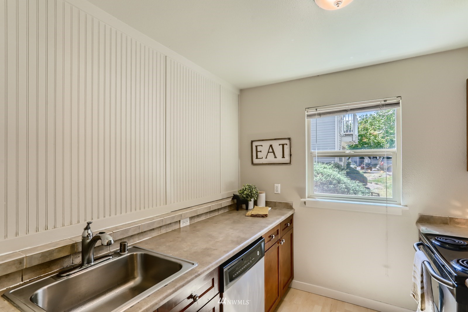 9805 Avondale Road Northeast, Unit X162 Redmond, WA 98052 - Photo 3 of 19 a kitchen with a sink cabinets and a window