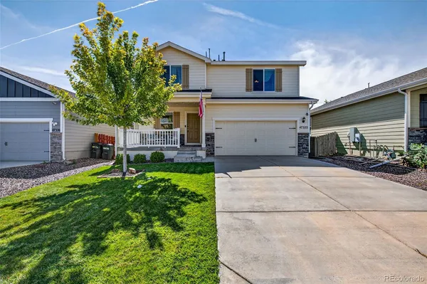a house view with a sitting space and garden