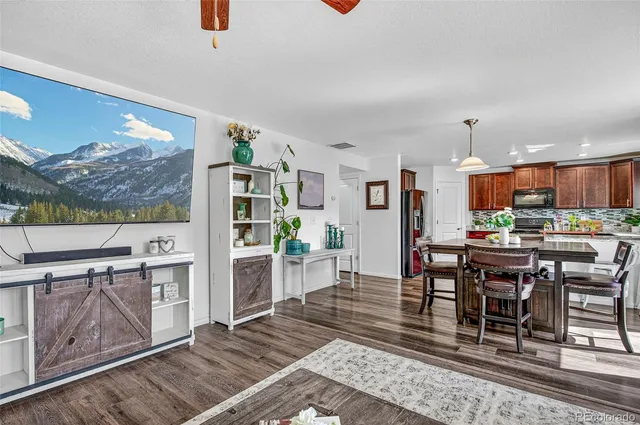 a view of a dining room with furniture window and wooden floor