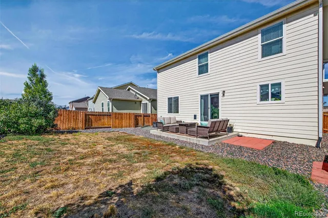a view of backyard with deck and seating area