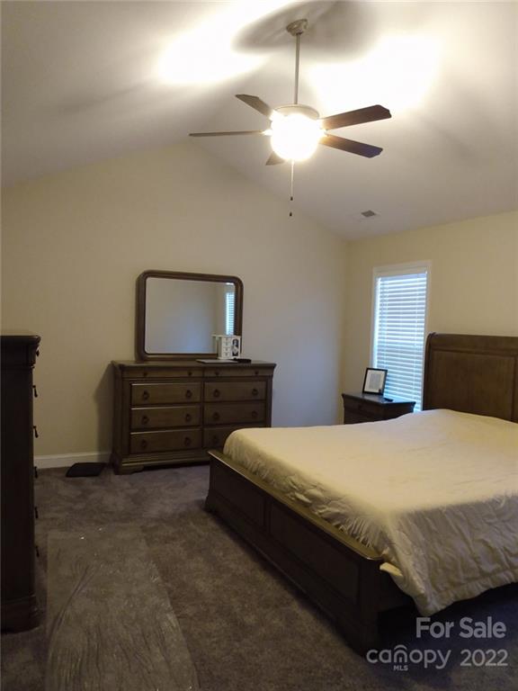 1114 Turtle Ridge Drive Monroe, NC 28110 - Photo 5 of 7 a bedroom with a bed and a chandelier