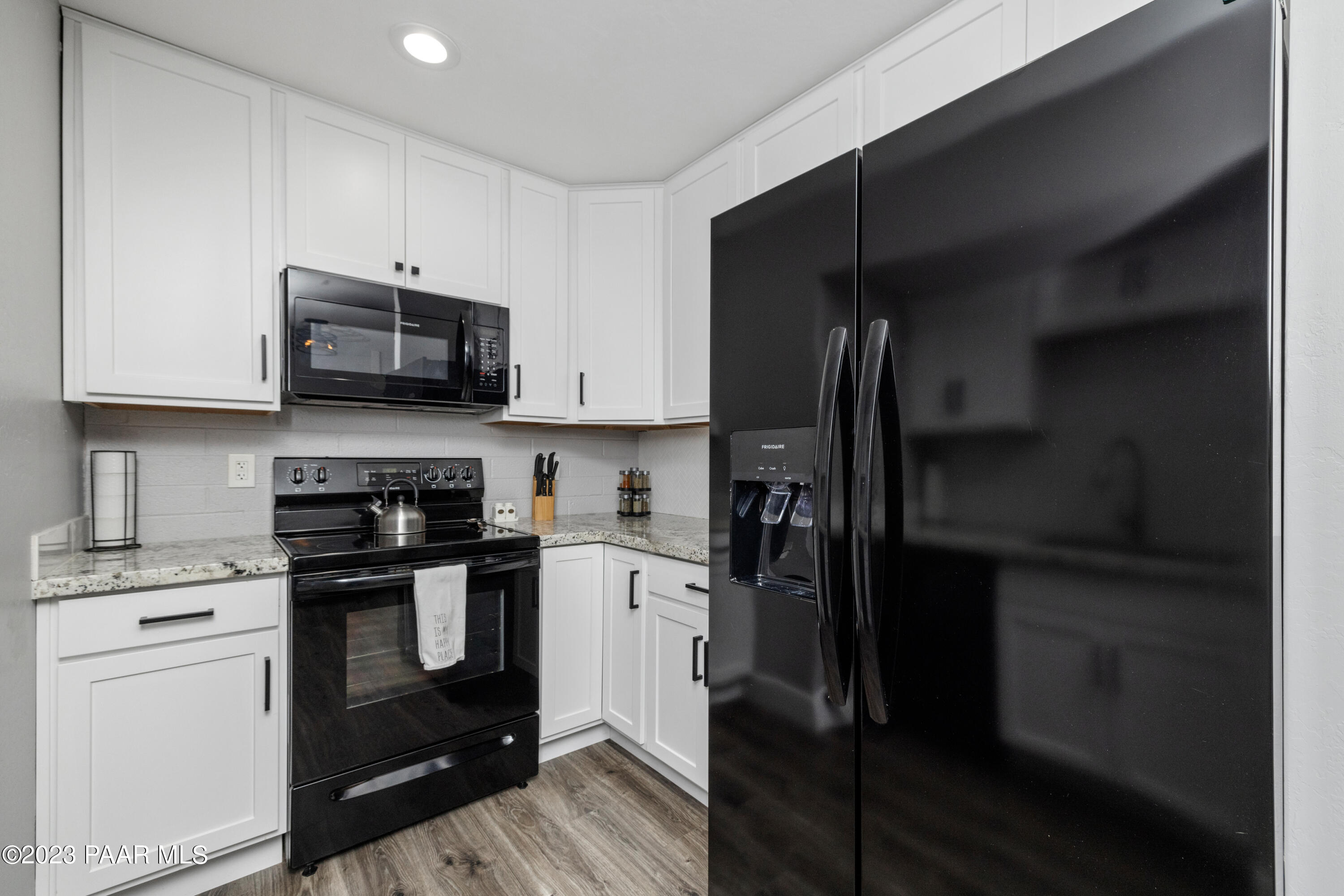 8339 Florentine Road, Unit 1 Prescott Valley, AZ 86314 - Photo 8 of 21 a kitchen with a refrigerator stove and microwave