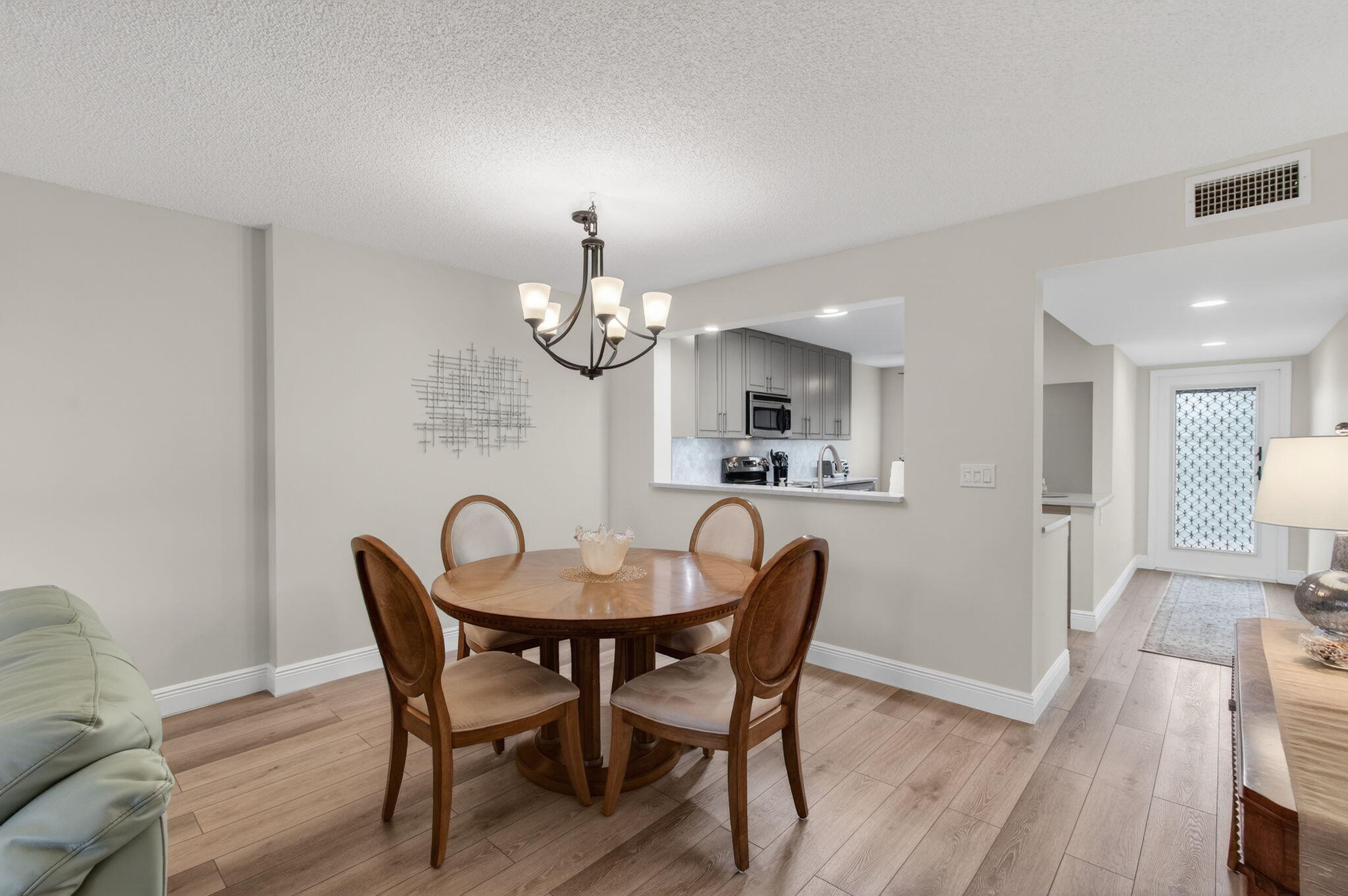 15074 Witney Road, Unit 204 Delray Beach, FL 33484 - Photo 18 of 56 a view of a dining room with furniture and wooden floor