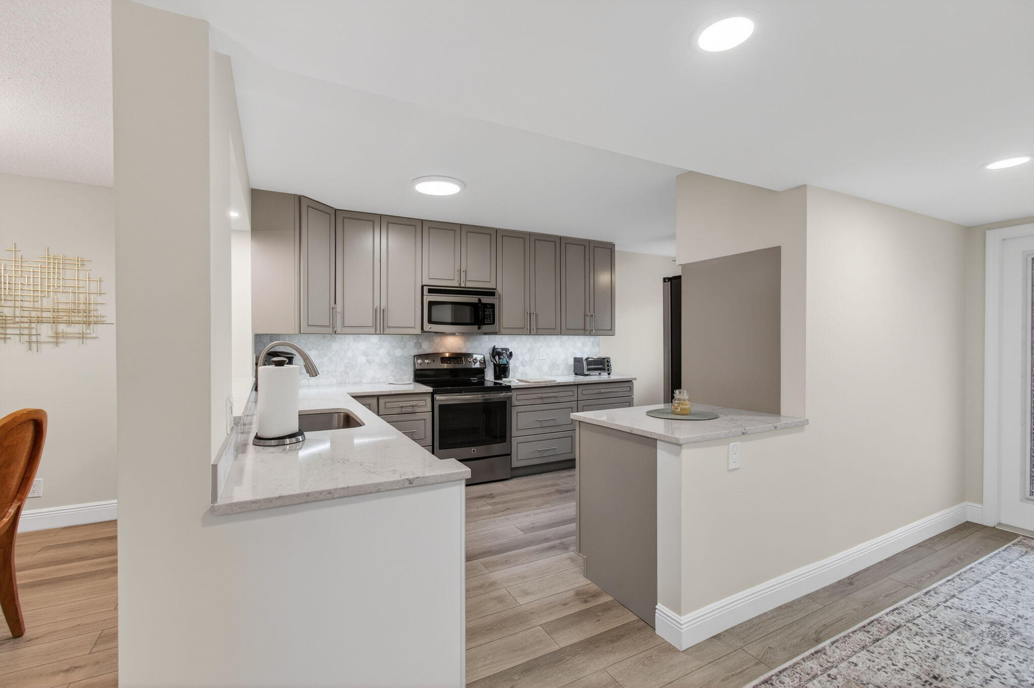 15074 Witney Road, Unit 204 Delray Beach, FL 33484 - Photo 19 of 56 a kitchen with a refrigerator cabinets and wooden floor