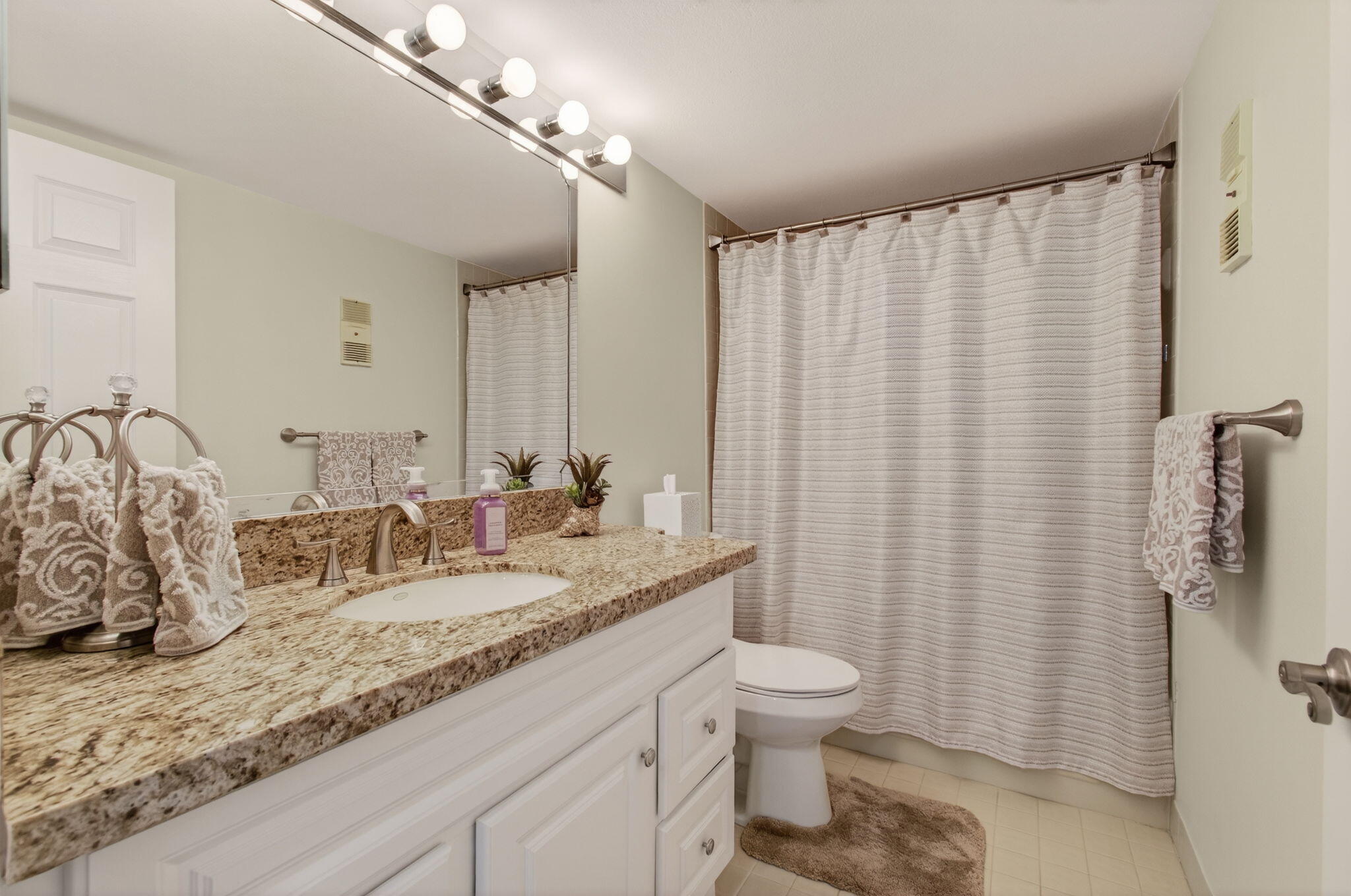 15074 Witney Road, Unit 204 Delray Beach, FL 33484 - Photo 39 of 56 a bathroom with a granite countertop sink and a mirror