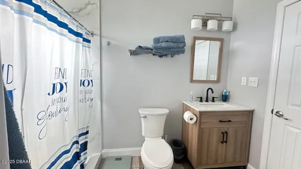 a bathroom with a toilet a sink and a mirror
