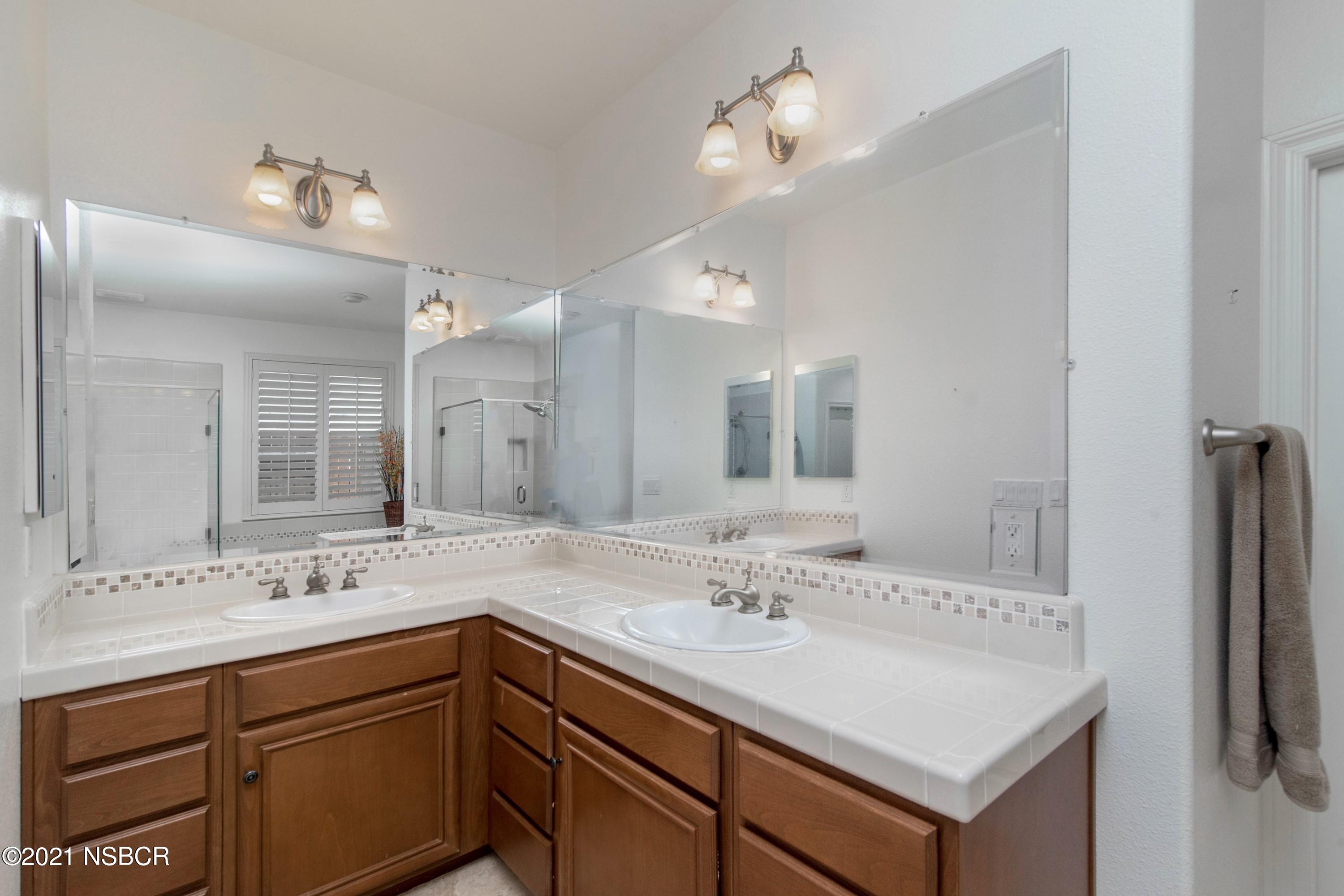3709 Jupiter Avenue Lompoc, CA 93436 - Photo 12 of 26 a bathroom with a sink double vanity granite and a mirror