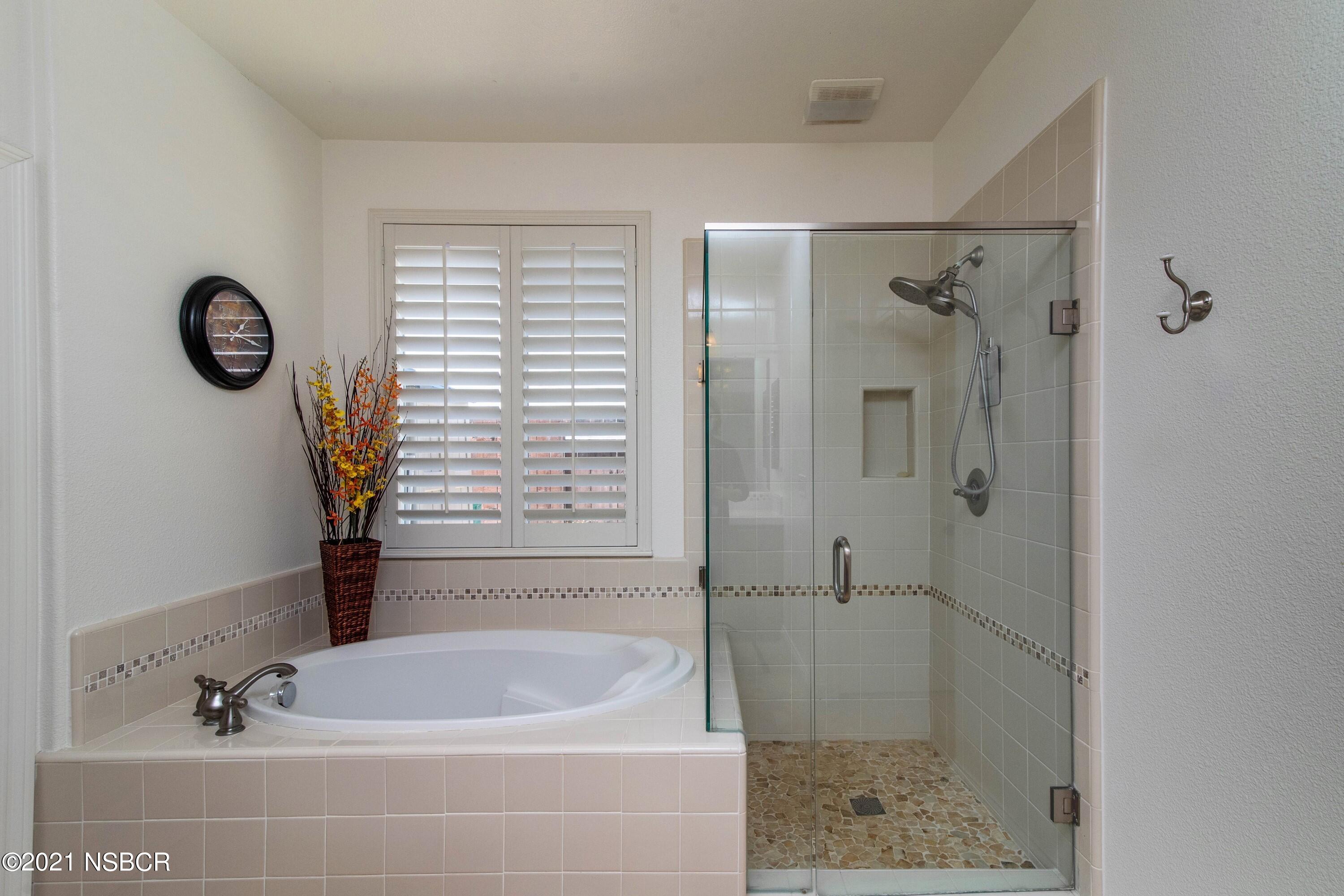 3709 Jupiter Avenue Lompoc, CA 93436 - Photo 14 of 26 a bathroom with a tub a window and a shower
