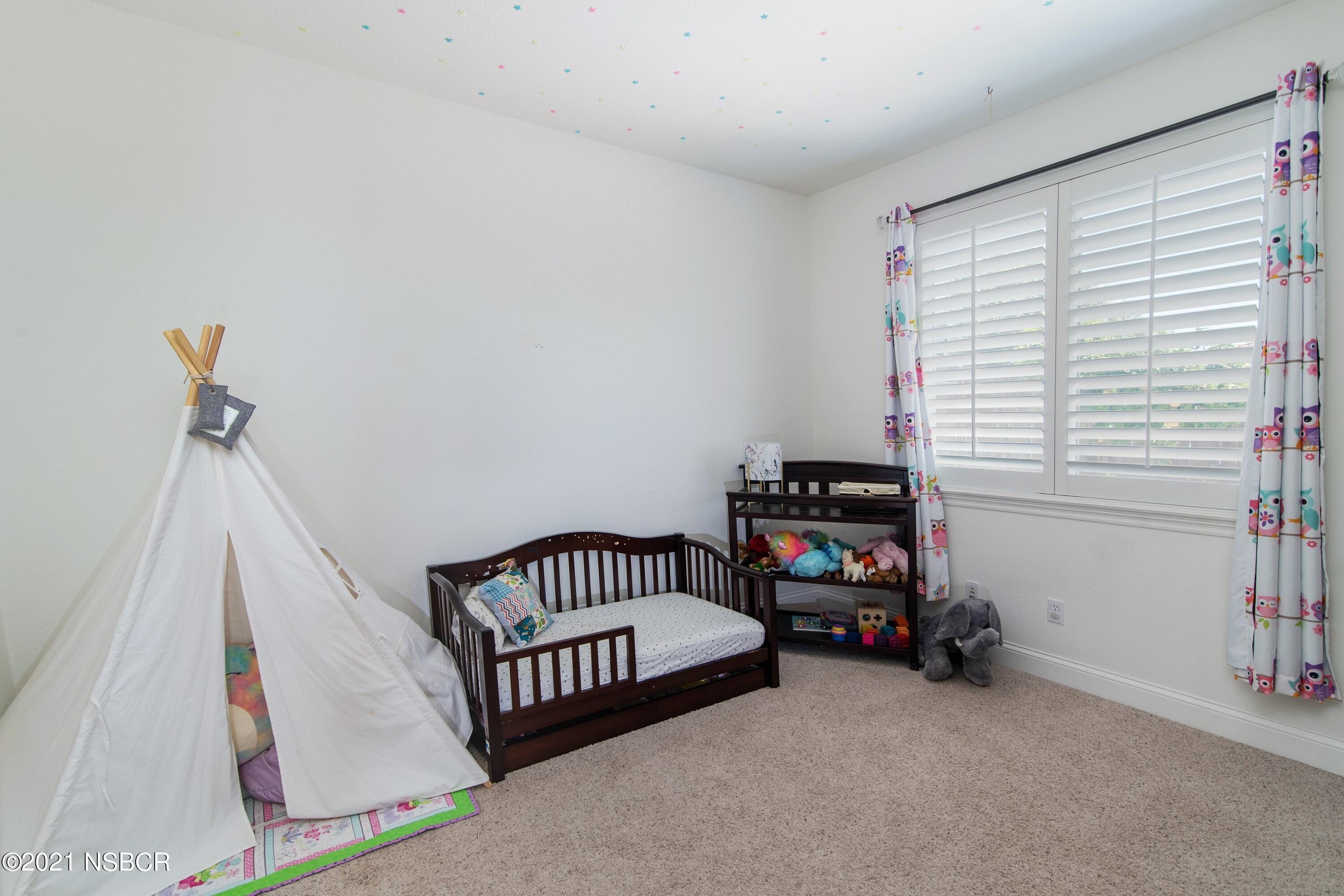 3709 Jupiter Avenue Lompoc, CA 93436 - Photo 16 of 26 a bedroom with a bed and a window