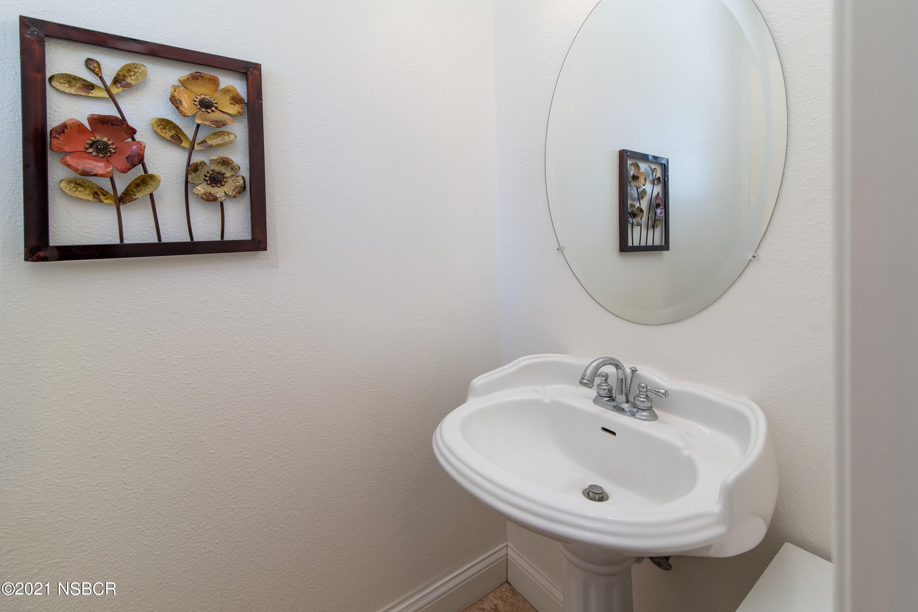 3709 Jupiter Avenue Lompoc, CA 93436 - Photo 18 of 26 a bathroom with a sink and a mirror