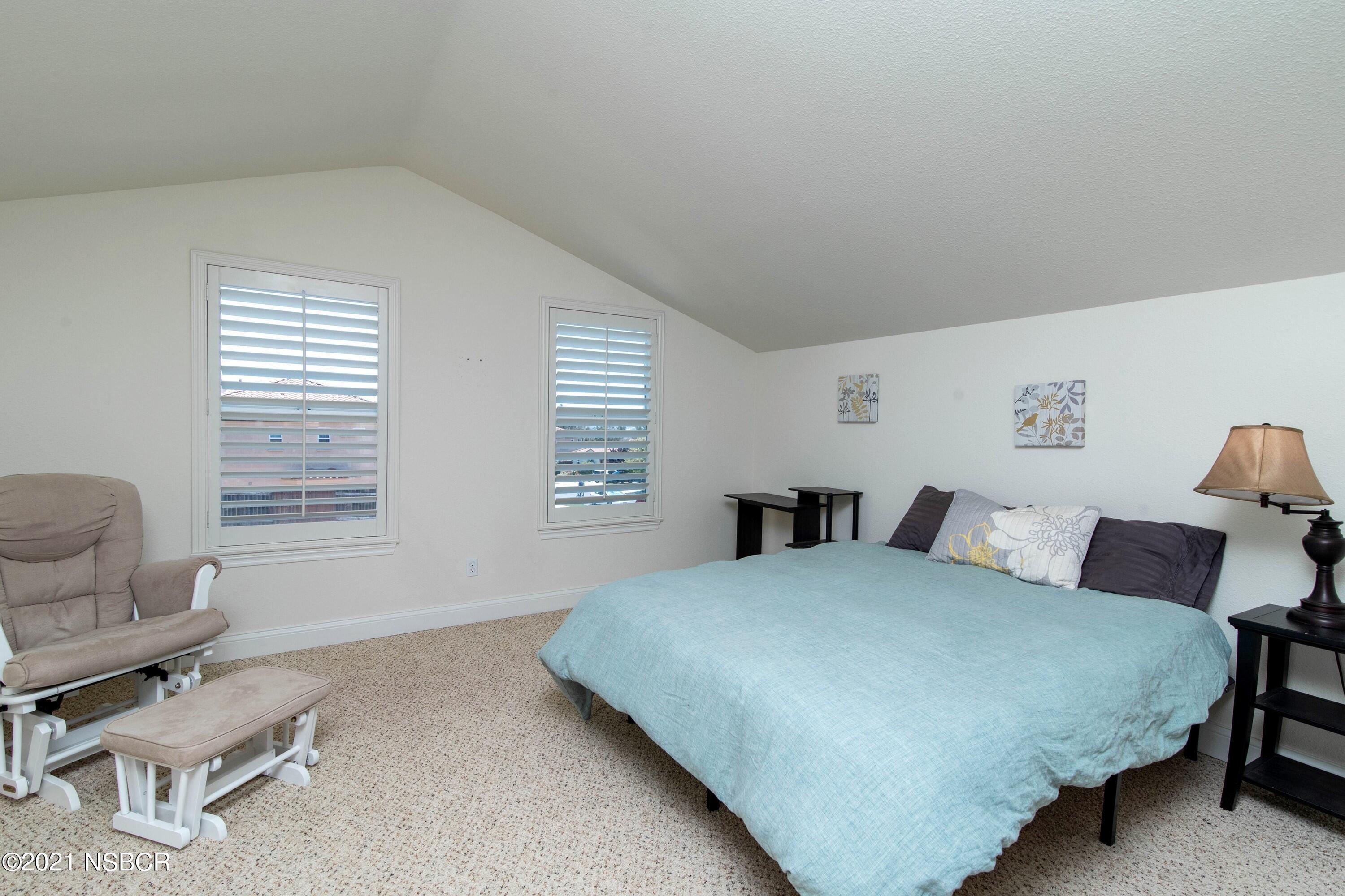 3709 Jupiter Avenue Lompoc, CA 93436 - Photo 21 of 26 a bedroom with a bed and a chair