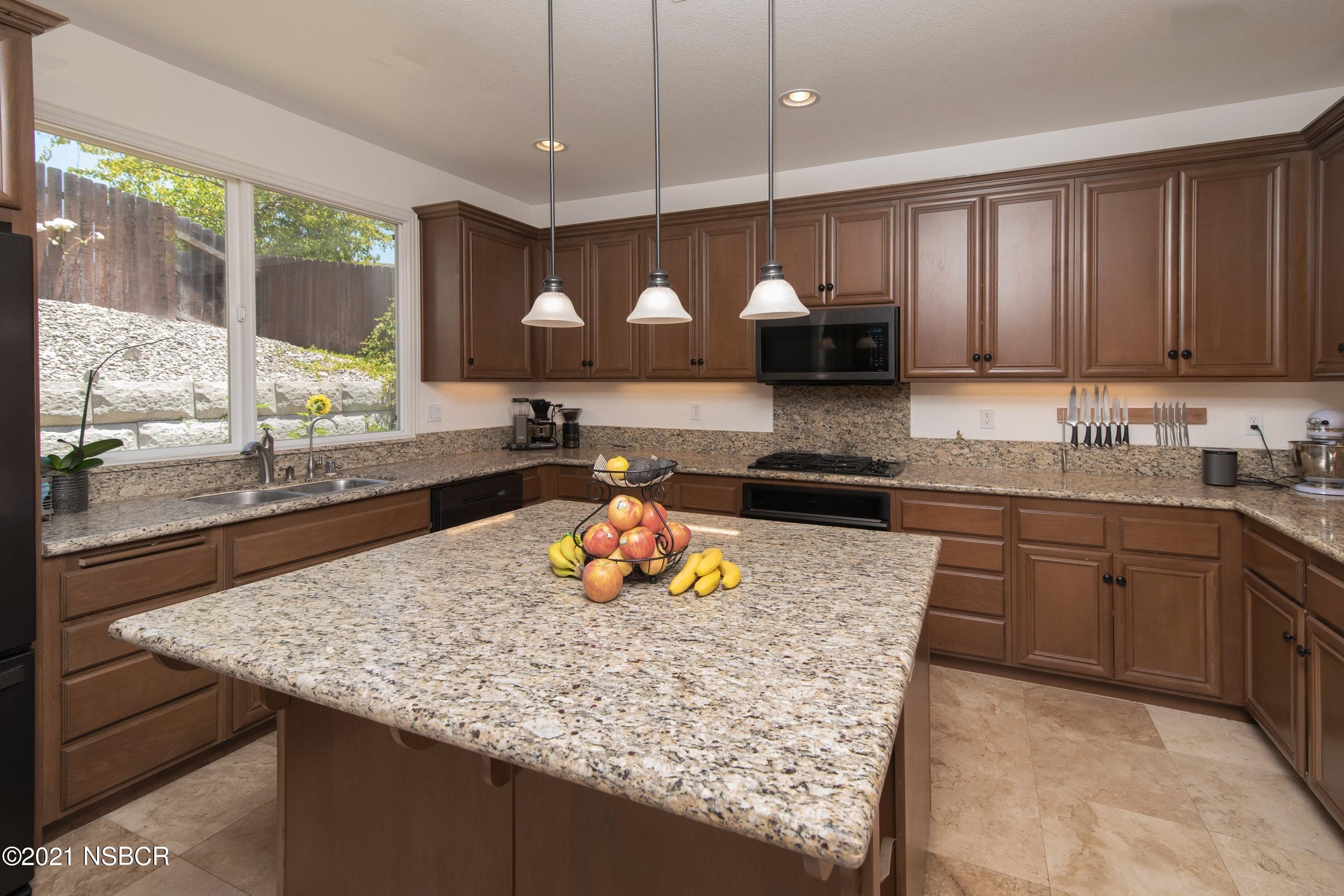 3709 Jupiter Avenue Lompoc, CA 93436 - Photo 6 of 26 a kitchen with a stove a sink a refrigerator and a counter top space