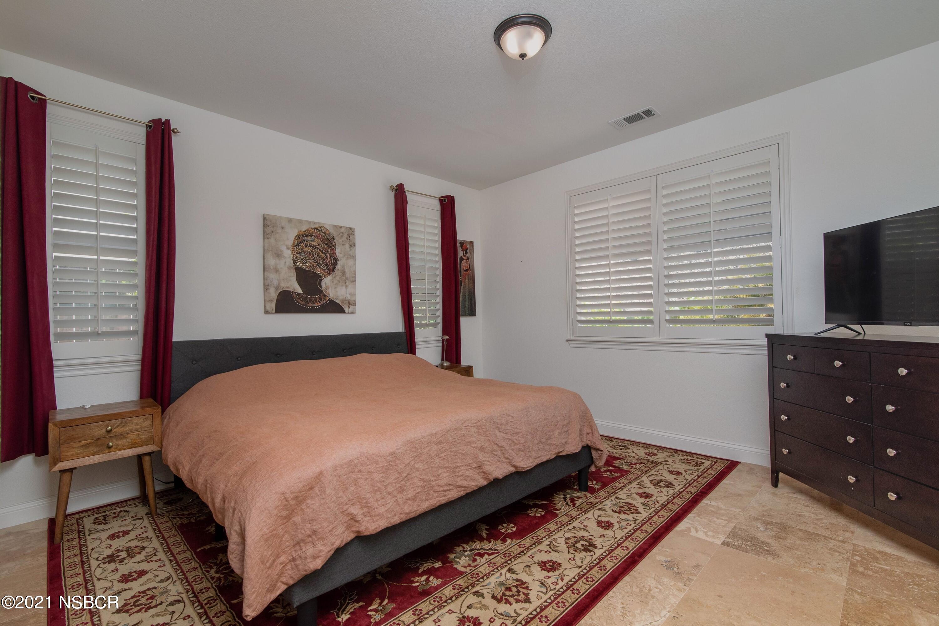3709 Jupiter Avenue Lompoc, CA 93436 - Photo 10 of 26 a bedroom with a bed and a flat screen tv