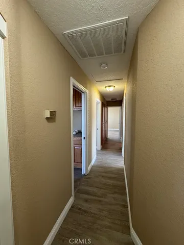 an empty room with wooden floor and closet