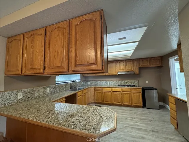 a kitchen with granite countertop cabinets and sink