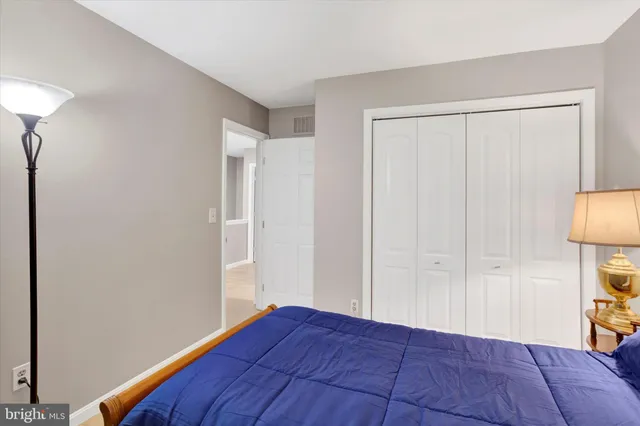 a bedroom with a bed and a lamp on table