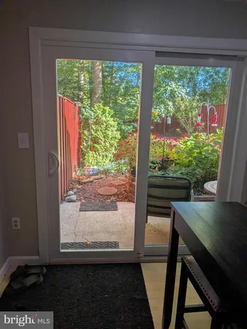a view of a room that has a bed door and a balcony