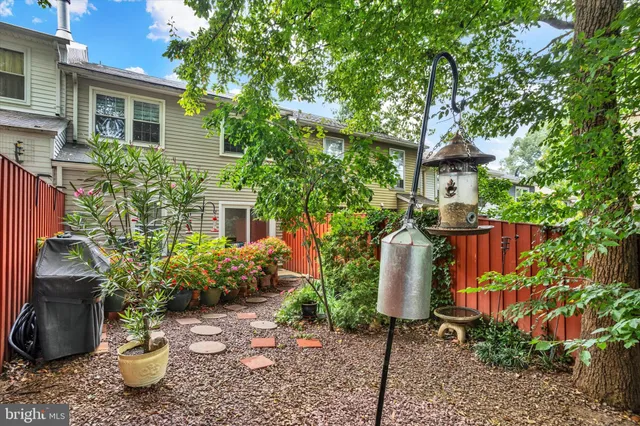 a view of a chairs and table in the backyard