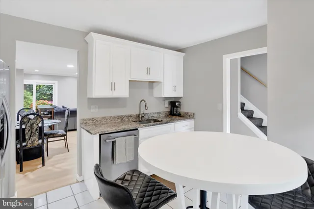 a kitchen with a stove a sink and a refrigerator
