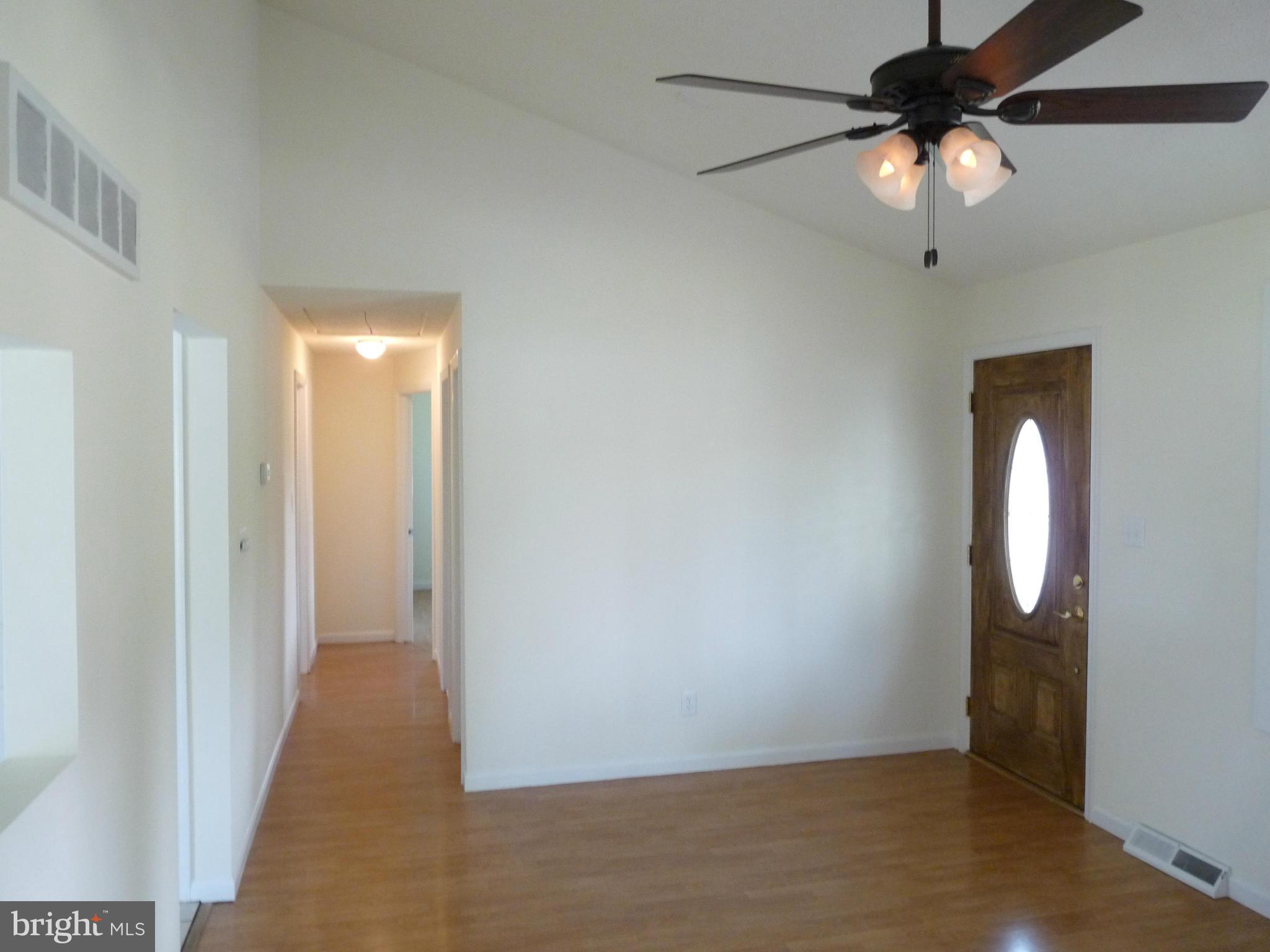 239 St Marys Road Essex, MD 21221 - Photo 8 of 30 Living Room with Cathedral Ceiling and Ceiling Fan