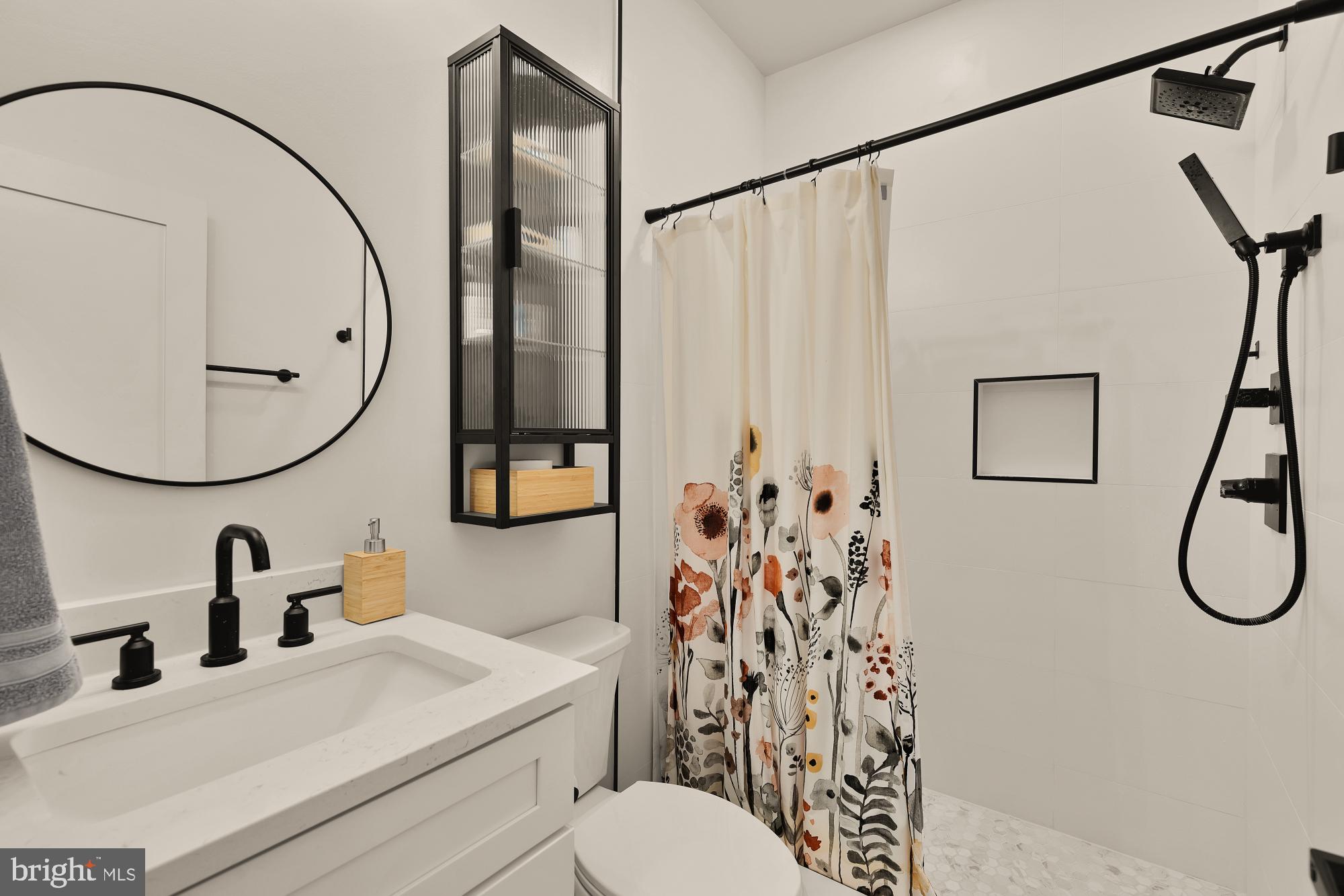 623 Kennedy Street Northwest, Unit 10 Washington, DC 20011 - Photo 15 of 29 a bathroom with a sink vanity mirror and toilet