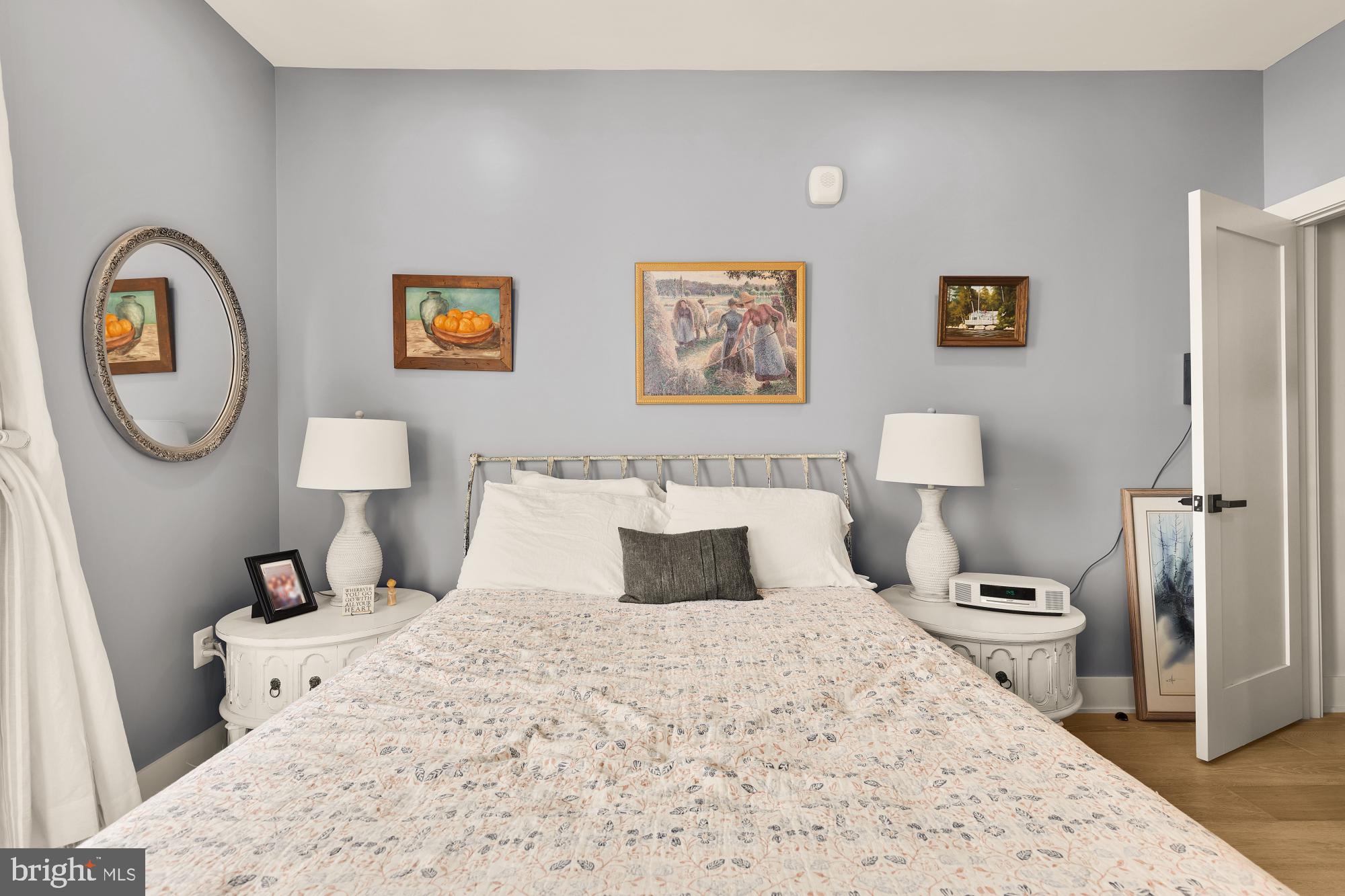 623 Kennedy Street Northwest, Unit 10 Washington, DC 20011 - Photo 21 of 29 a bedroom with a bed and a lamp on dresser