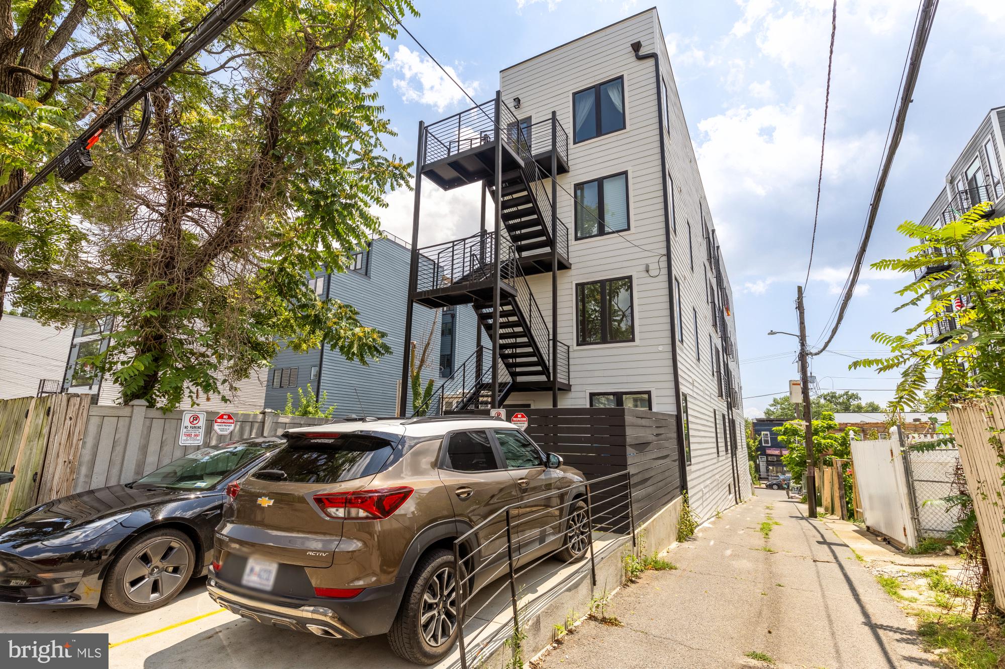 623 Kennedy Street Northwest, Unit 10 Washington, DC 20011 - Photo 29 of 29 a car parked in front of a brick house