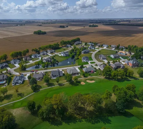an aerial view of a house with yard swimming pool and outdoor seating