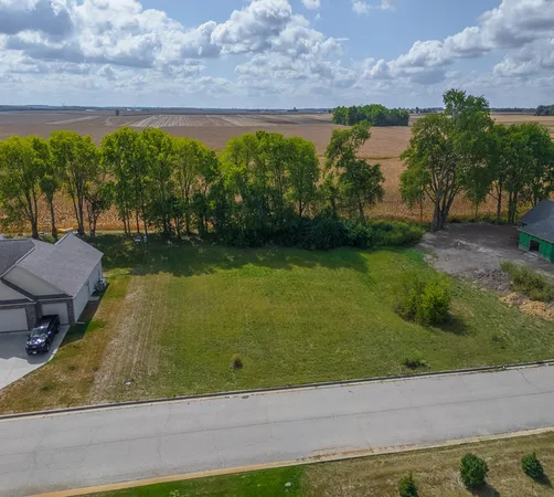 an aerial view of a residential houses with outdoor space