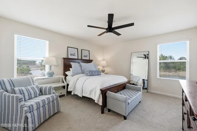 a bedroom with a bed couch and window