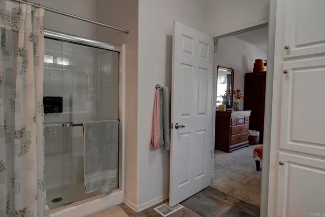 a bathroom with a glass shower door