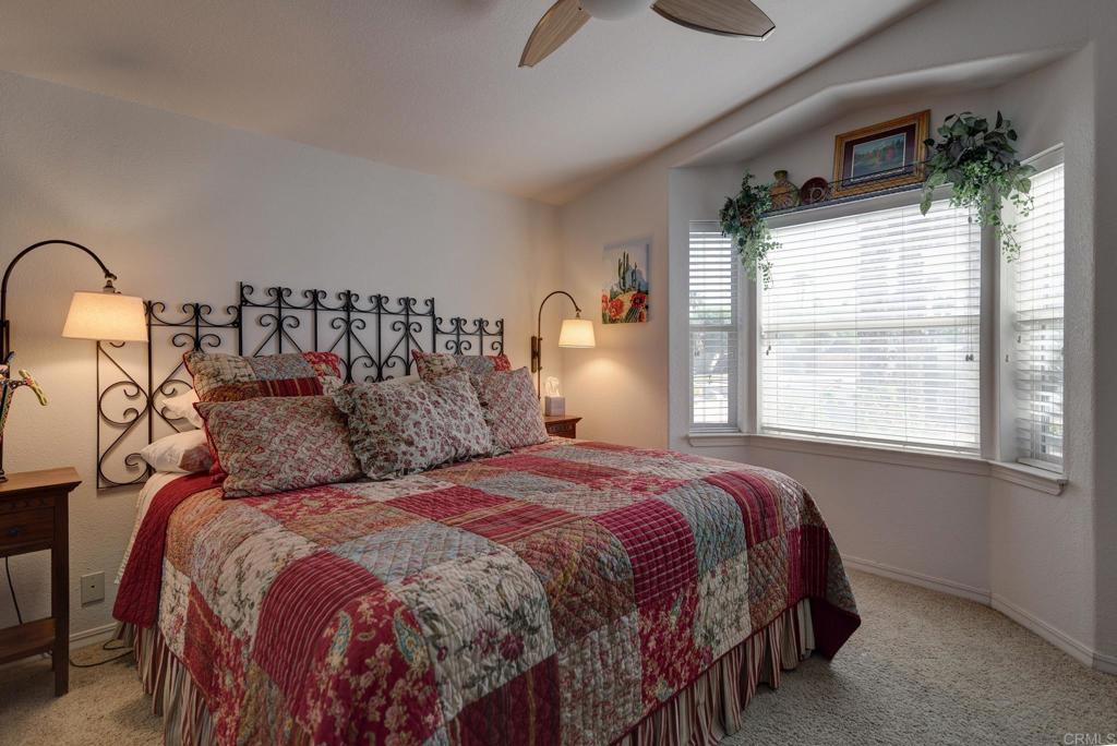 1010 Palm Canyon Drive, Unit 368 Borrego Springs, CA 92004 - Photo 14 of 23 a bedroom with a bed a mirror and a large window