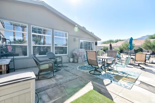 a building outdoor space with patio furniture and potted plants