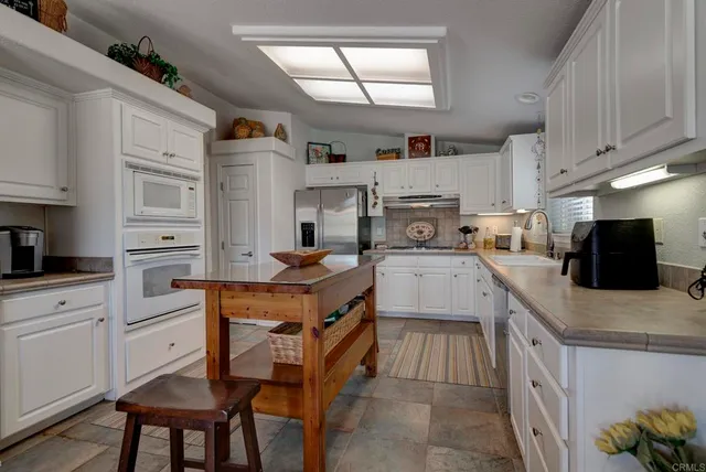 a kitchen with cabinets and wooden floor