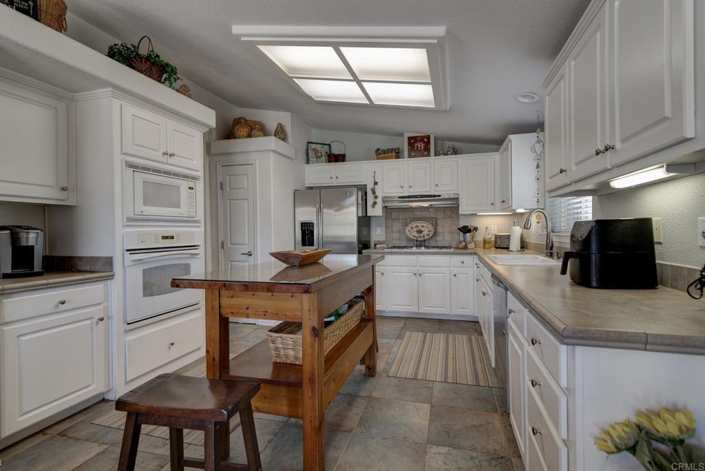 1010 Palm Canyon Drive, Unit 368 Borrego Springs, CA 92004 - Photo 3 of 23 a kitchen with cabinets and wooden floor