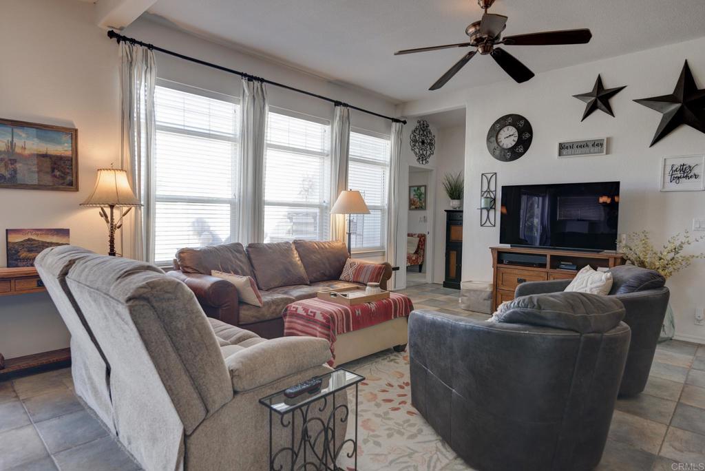 1010 Palm Canyon Drive, Unit 368 Borrego Springs, CA 92004 - Photo 4 of 23 a living room with furniture a ceiling fan and a large window
