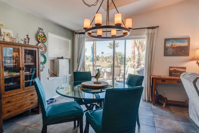a dining room with furniture a chandelier and window