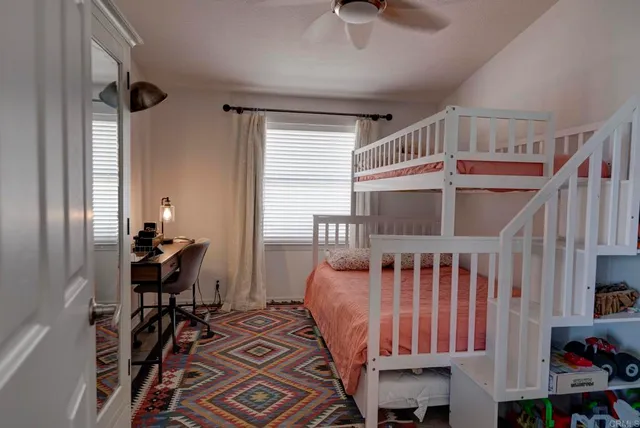 a bedroom with furniture and a window